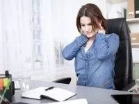 Woman in Office Chair Holding Neck, Appearing in Pain — Dwyer Law Group in Surfers Paradise, QLD
