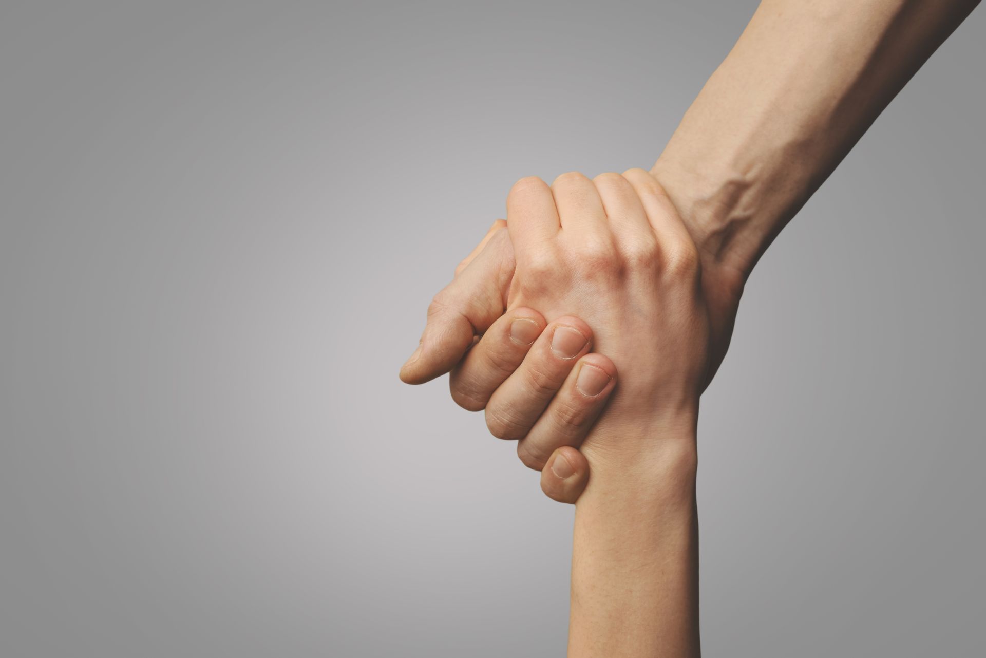 Hand of One Person Gripping the Hand of Another, Offering Support — Dwyer Law Group in Surfers Paradise, QLD