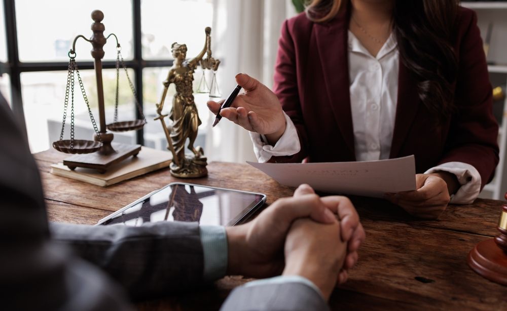 Lawyer in Burgundy Jacket Discussing Documents — Dwyer Law Group in Surfers Paradise, QLD