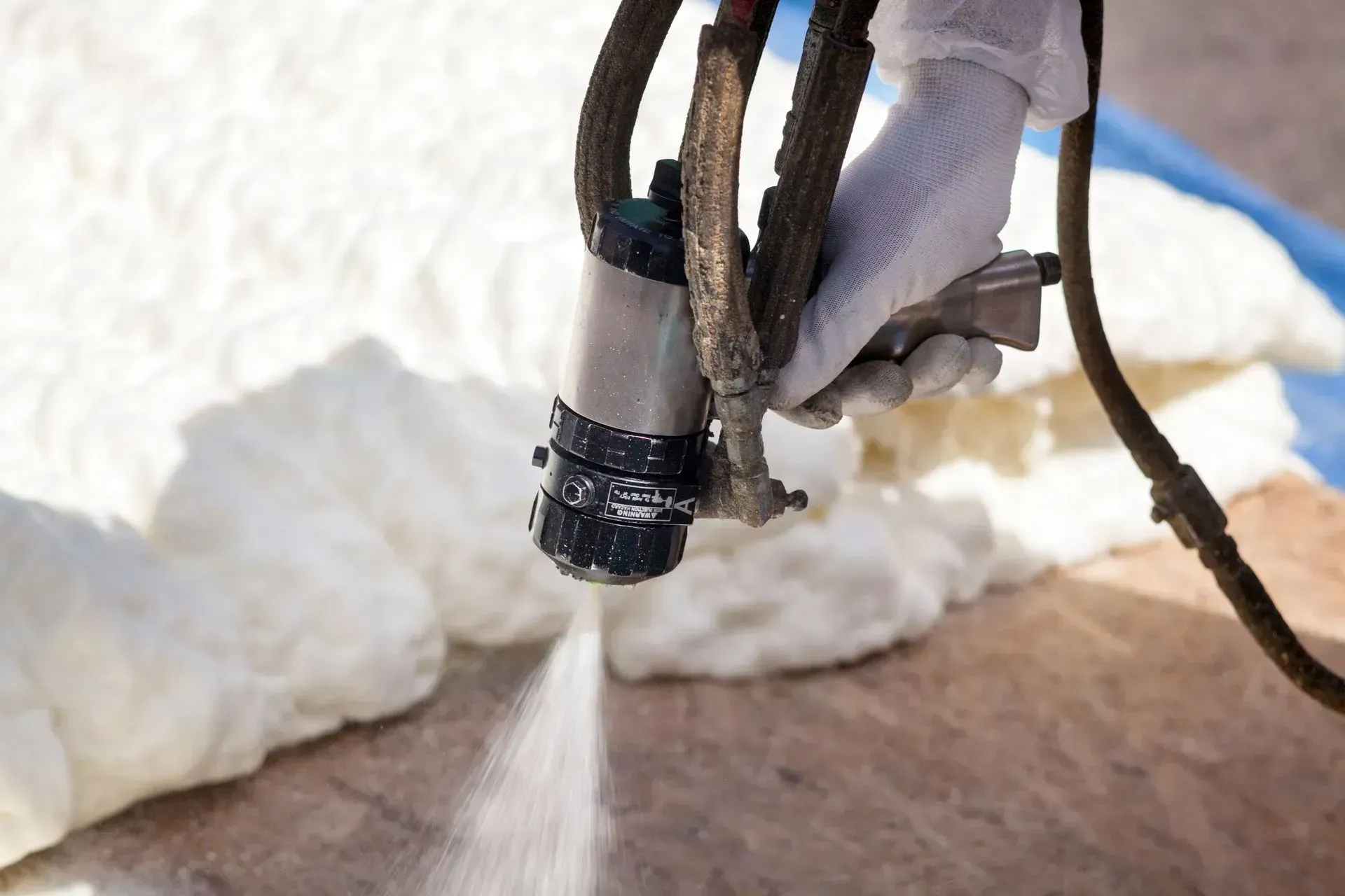Wet concrete pouring from a truck chute onto a construction site, forming a gravelly slab surface