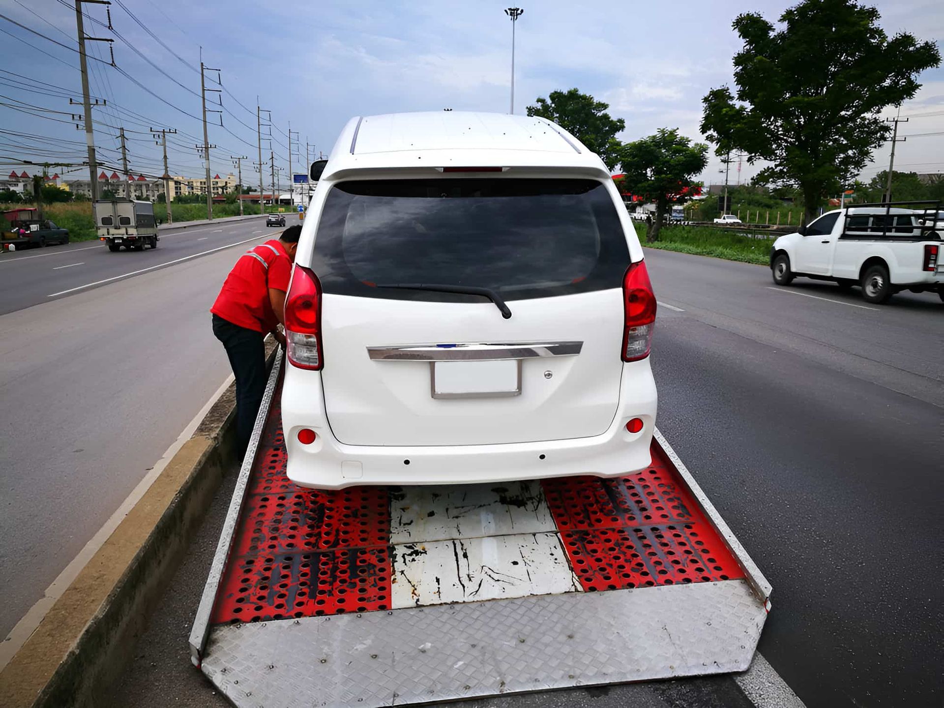 A White Car Is Being Towed By A Tow Truck — Red Central Towing & Recovery In Alice Springs, NT