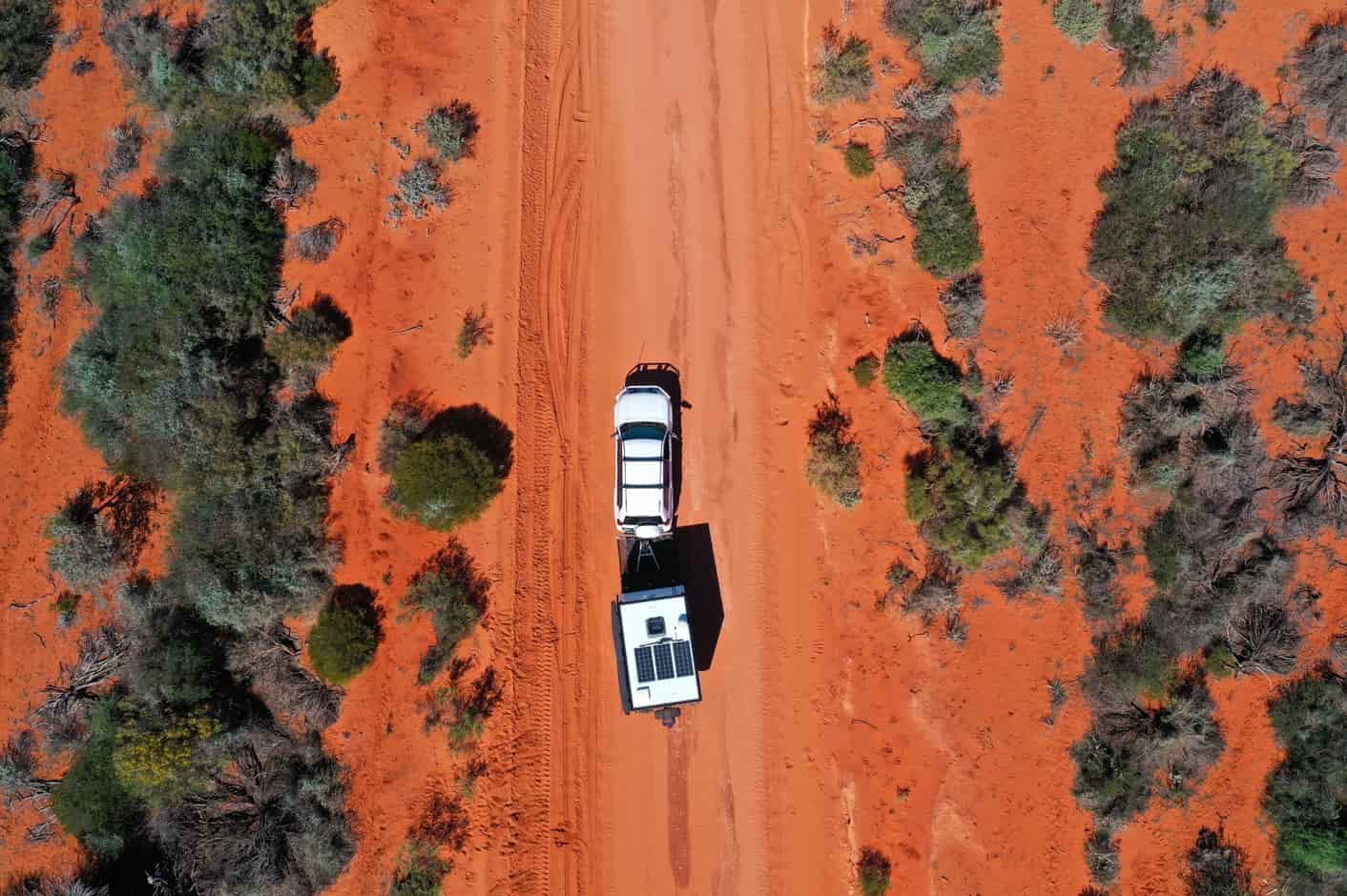 An Aerial View of a Truck Driving Down a Dirt Road in the Desert — Red Central Towing & Recovery In Alice Springs, NT