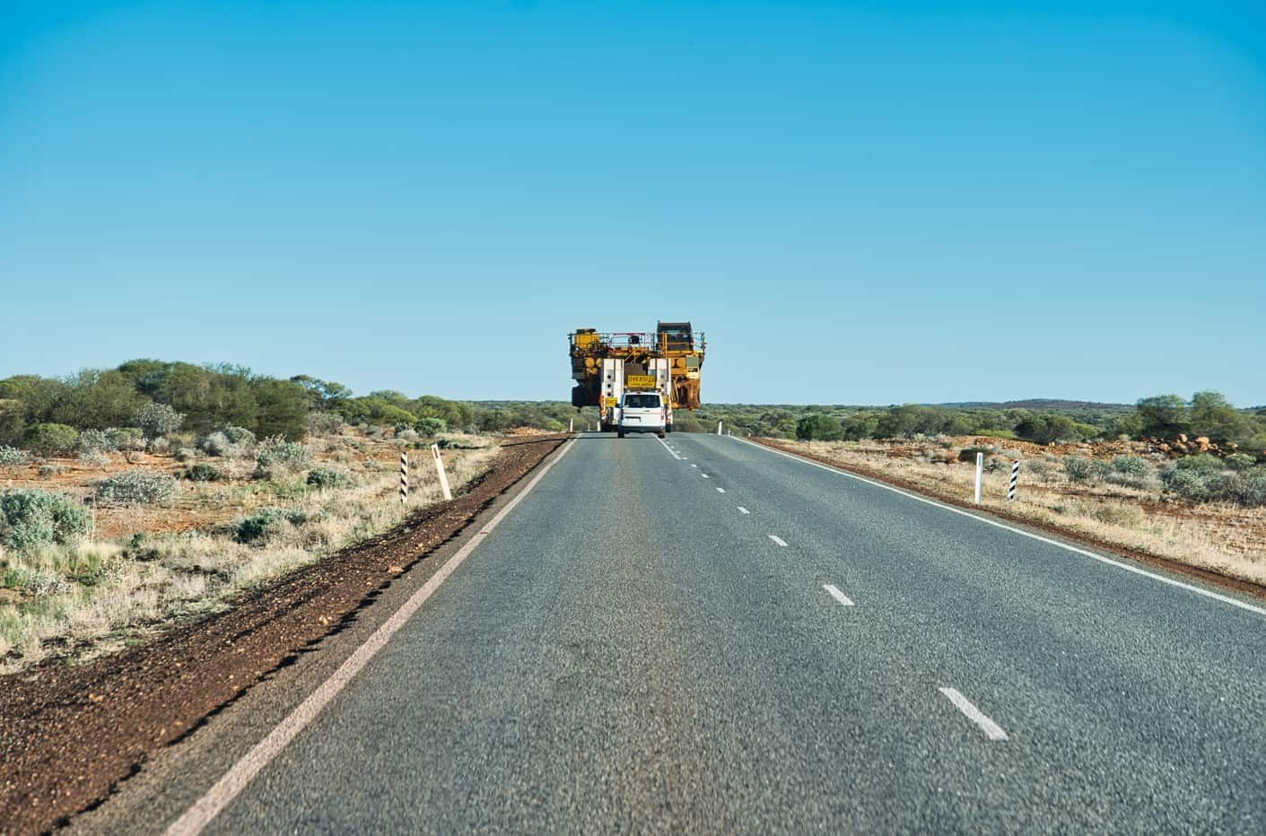 A Truck is Driving Down a Highway in the Desert — Red Central Towing & Recovery In Alice Springs, NT