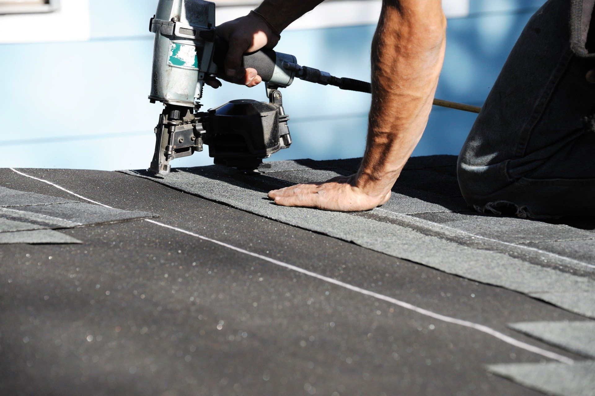 Roofer installing shingles on a Pembroke Pines home
