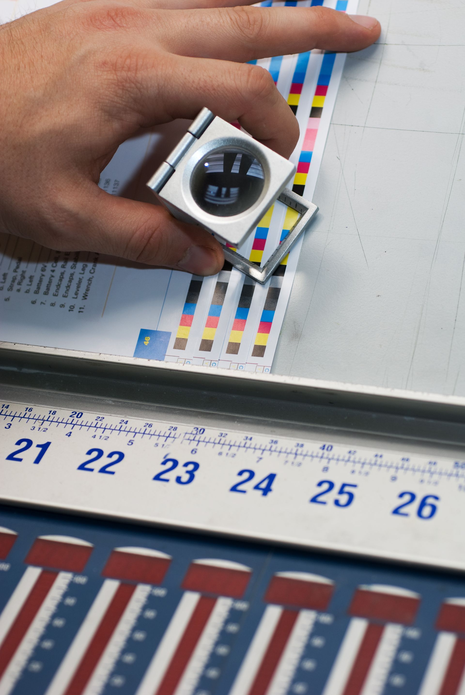 Technician calibrating color accuracy on printed materials for precision commercial printing services.