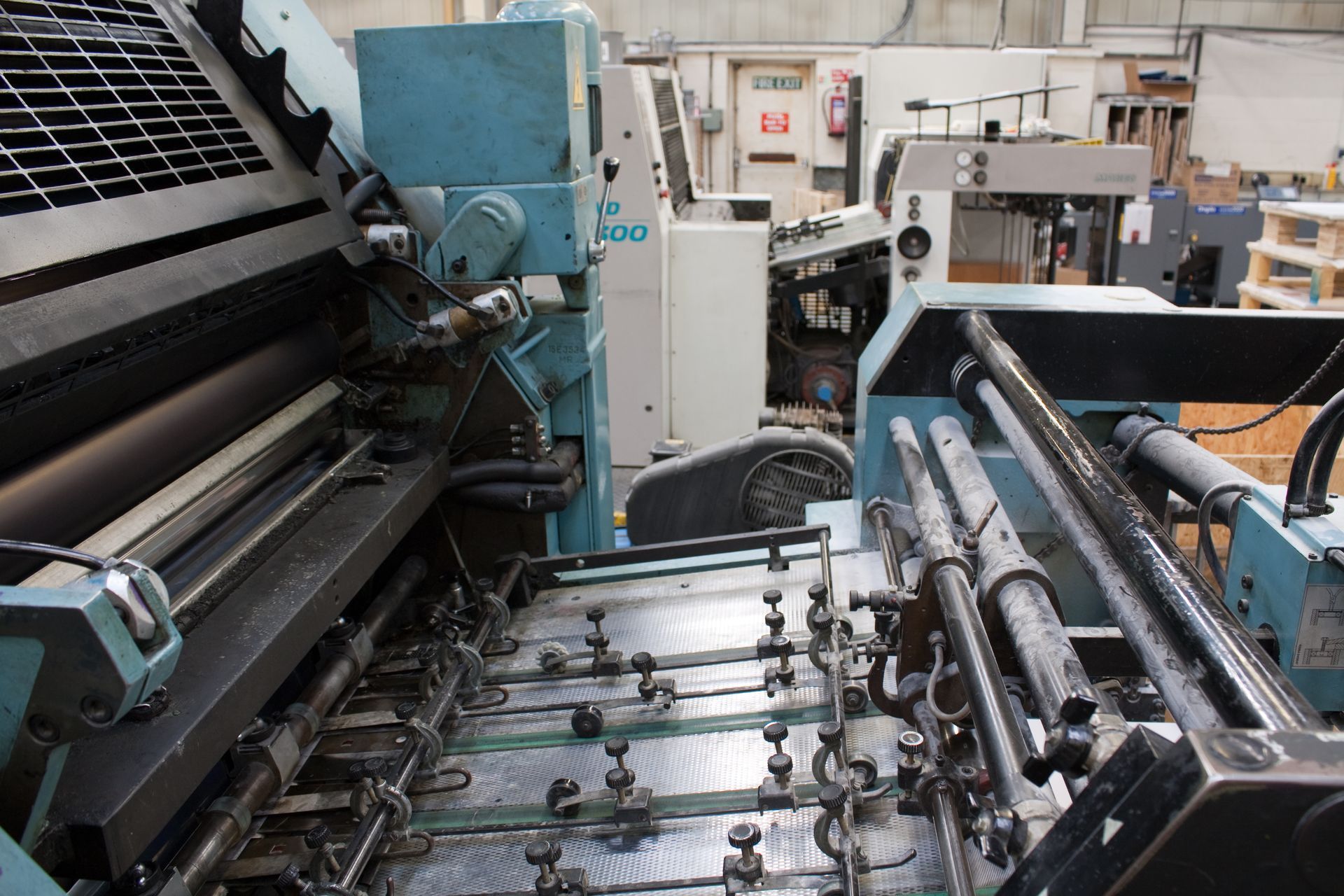 Industrial litho printing machine for high-volume commercial printing of brochures, business cards, and large-format materials.