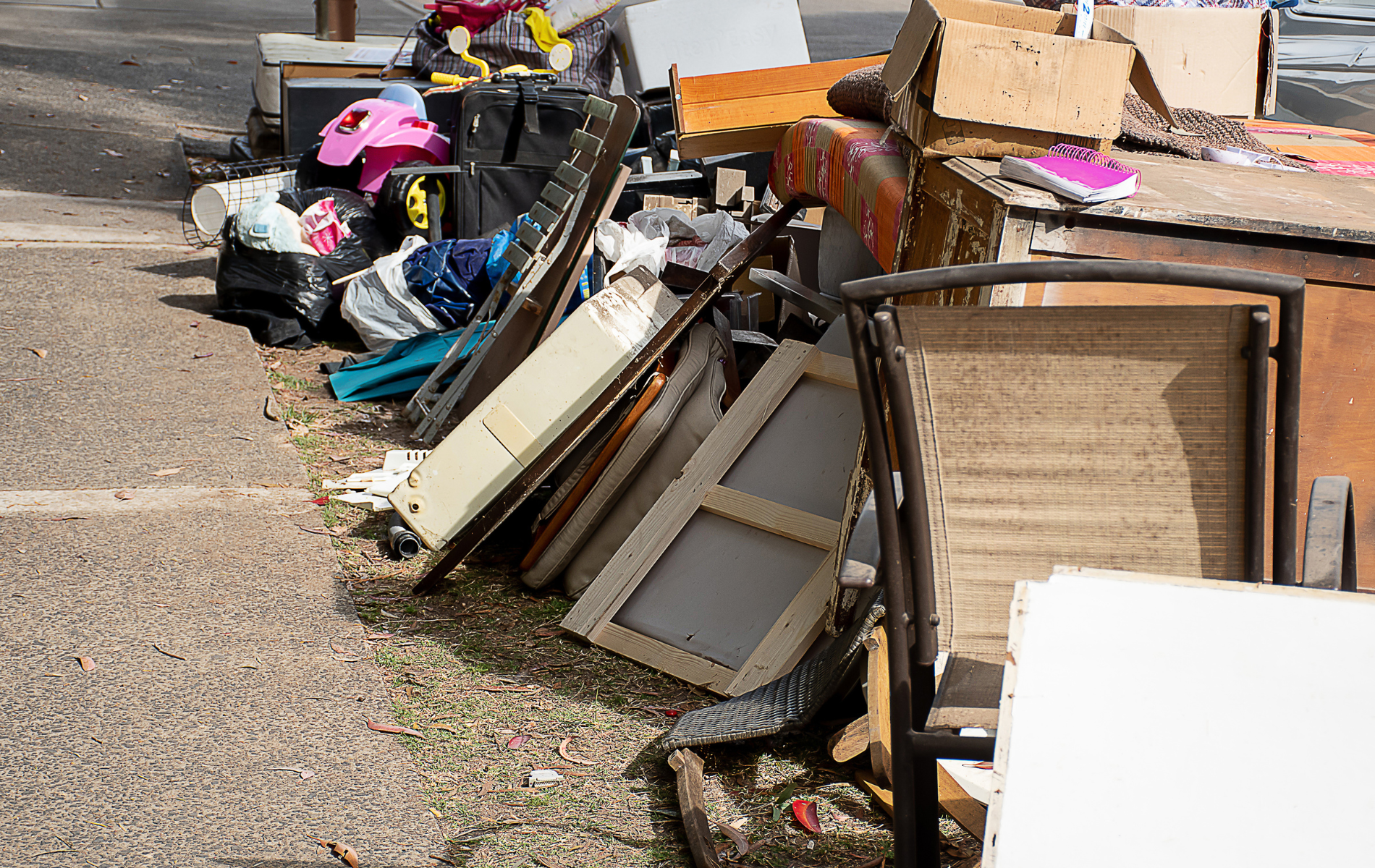 A pile of junk is sitting on the side of the road.
