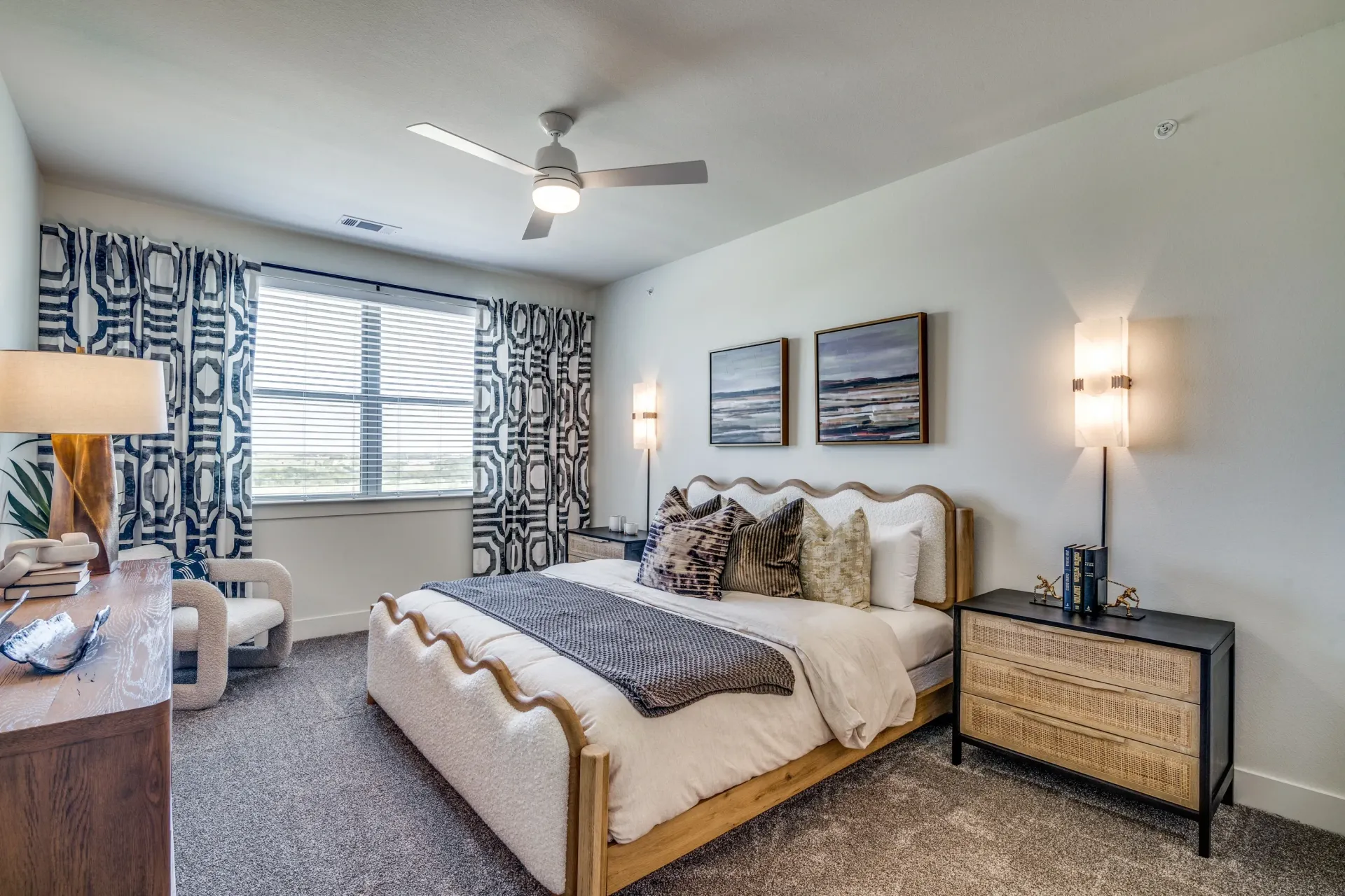 Stylish bedroom with a plush bed, decorative pillows, and modern nightstands.