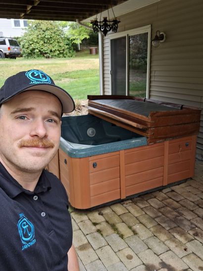 Cluttered garage with pool table, treadmill, hot tub, bike, and various items.