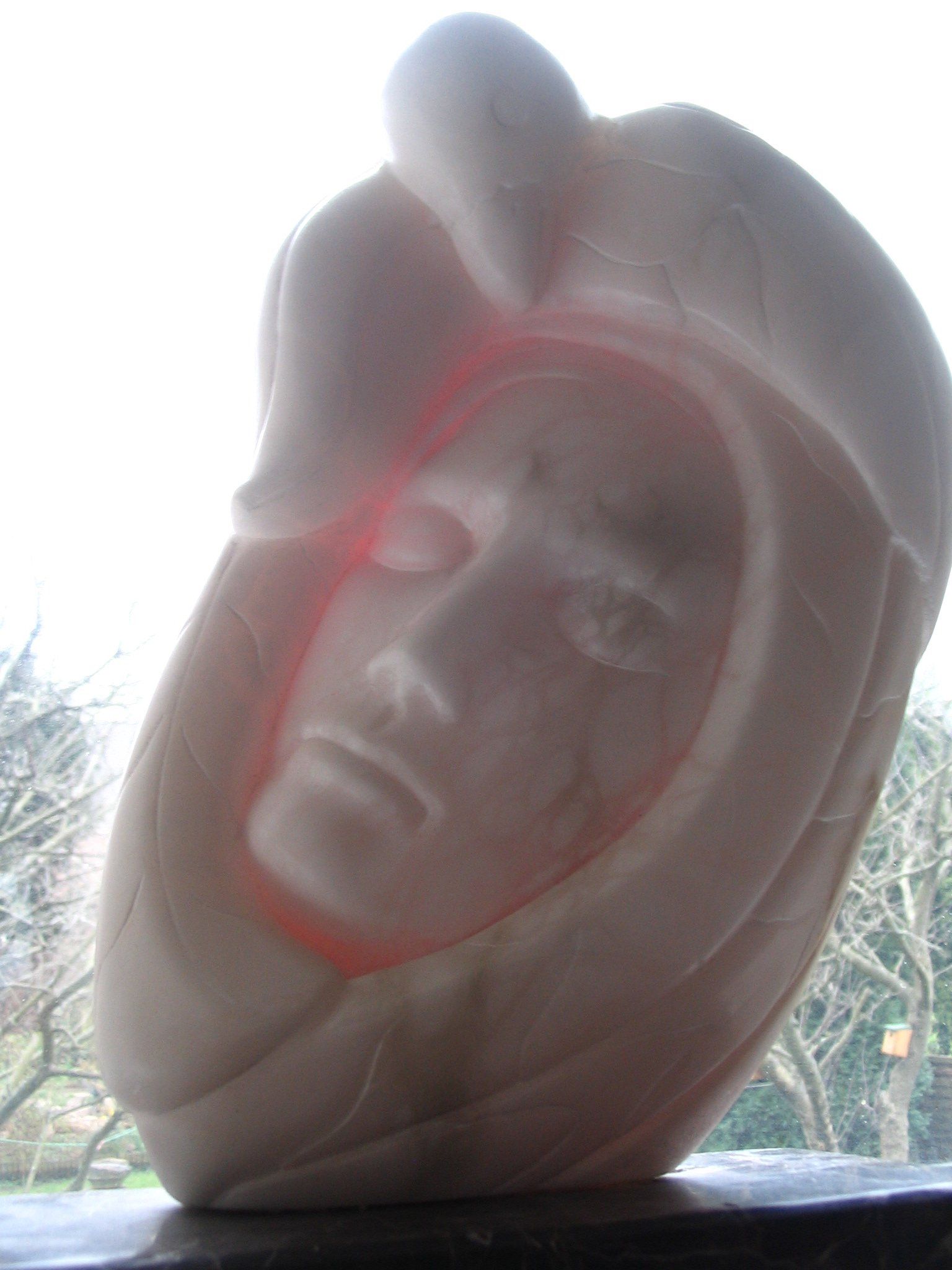 Stone and stained glass stone sculpture. Human. Bird