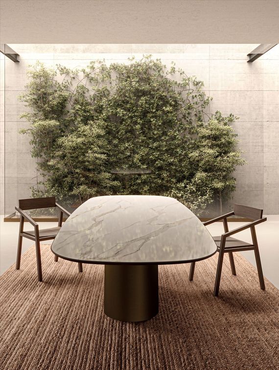 Patio moderno con tavolo in marmo, due sedie e una rigogliosa parete verde sullo sfondo.
