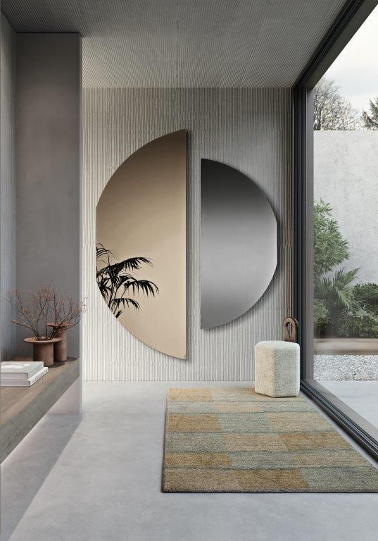 Corridoio moderno con decorazioni ad arco sulle pareti, pareti grigie a righe, un tappeto, una pianta in vaso e una finestra a tutta altezza.