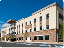 A large building with a parking lot in front of it