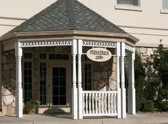 A white porch with a sign that says pediatrics on it