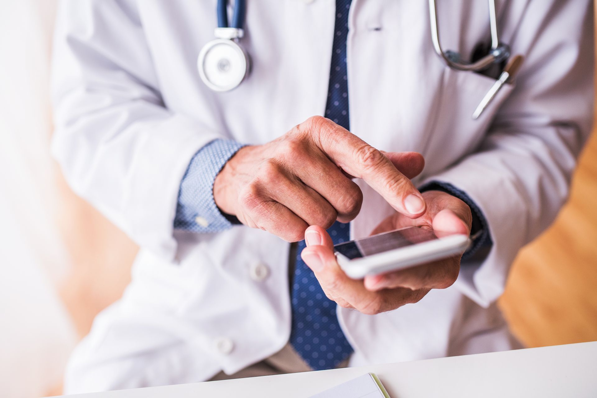 Doctor holding a mobile phone.