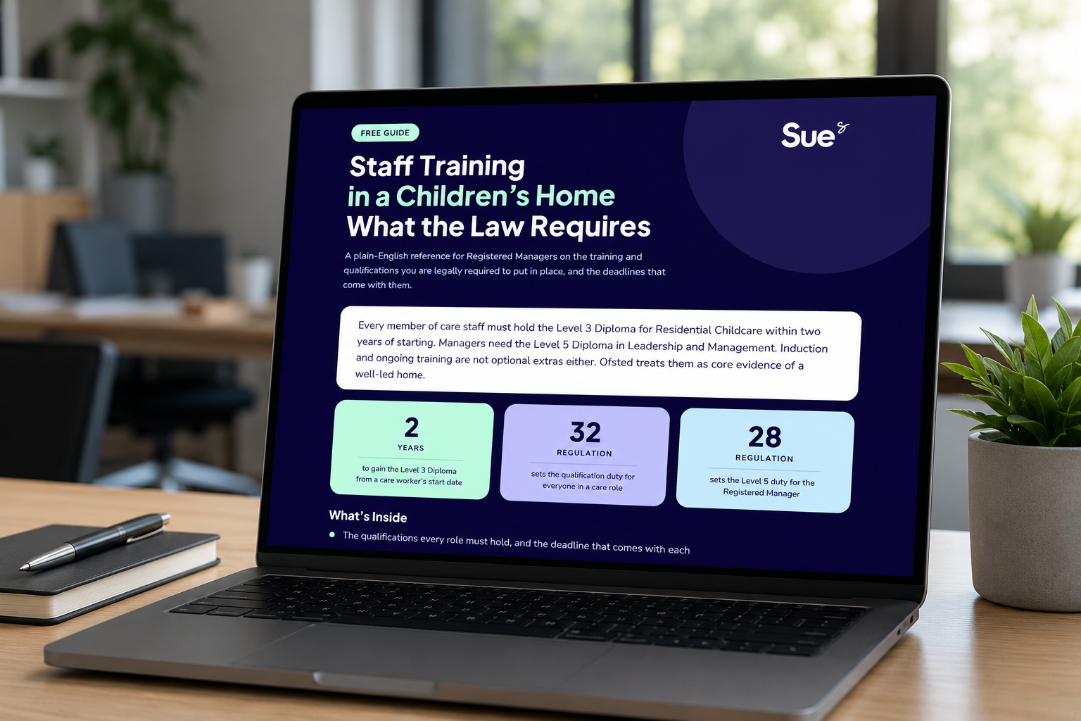 Laptop on desk showing a purple law infographic about staffing in a children's home