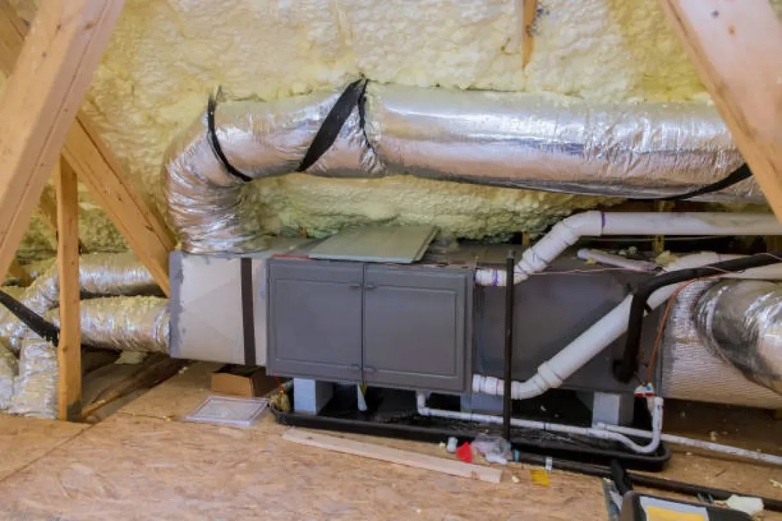 There is a ventilation system in the attic of a house.