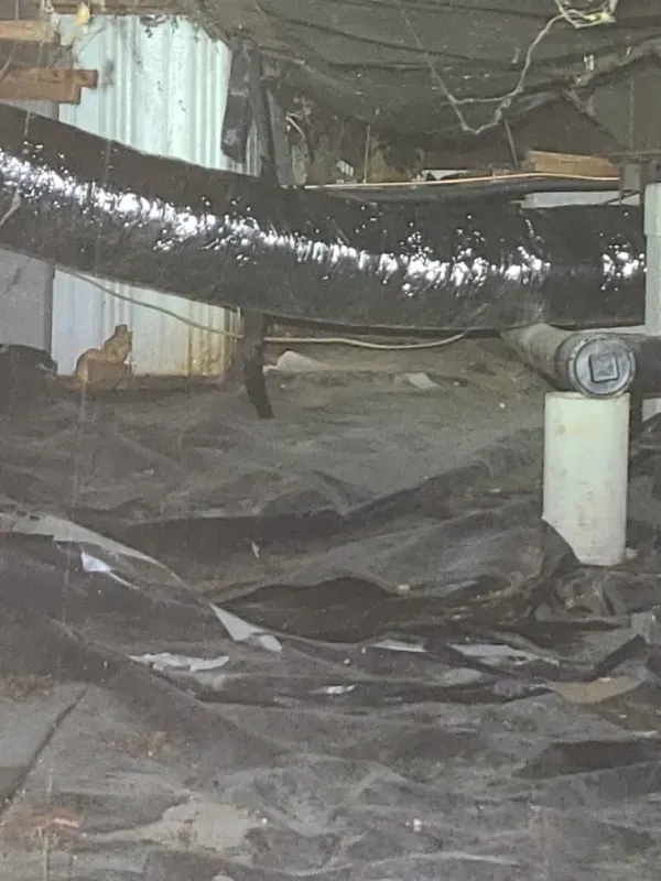 There is a large pipe in the corner of the room.