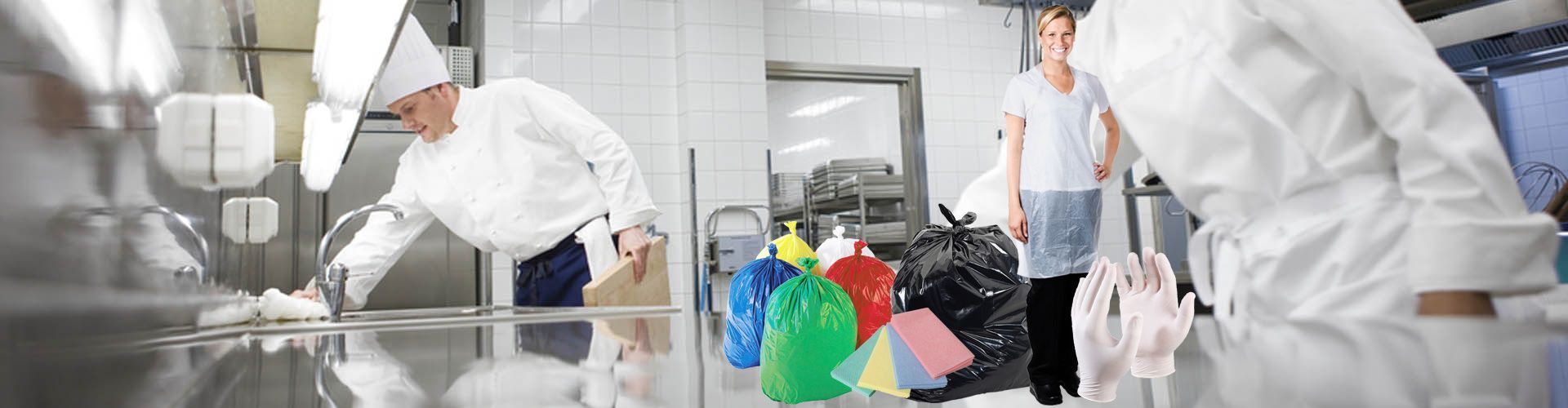 a group of chefs are cleaning a stainless steel counter in a kitchen .