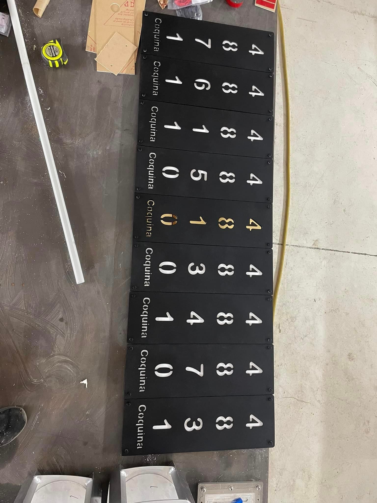 Black panels with white numbers and text on a floor. 
