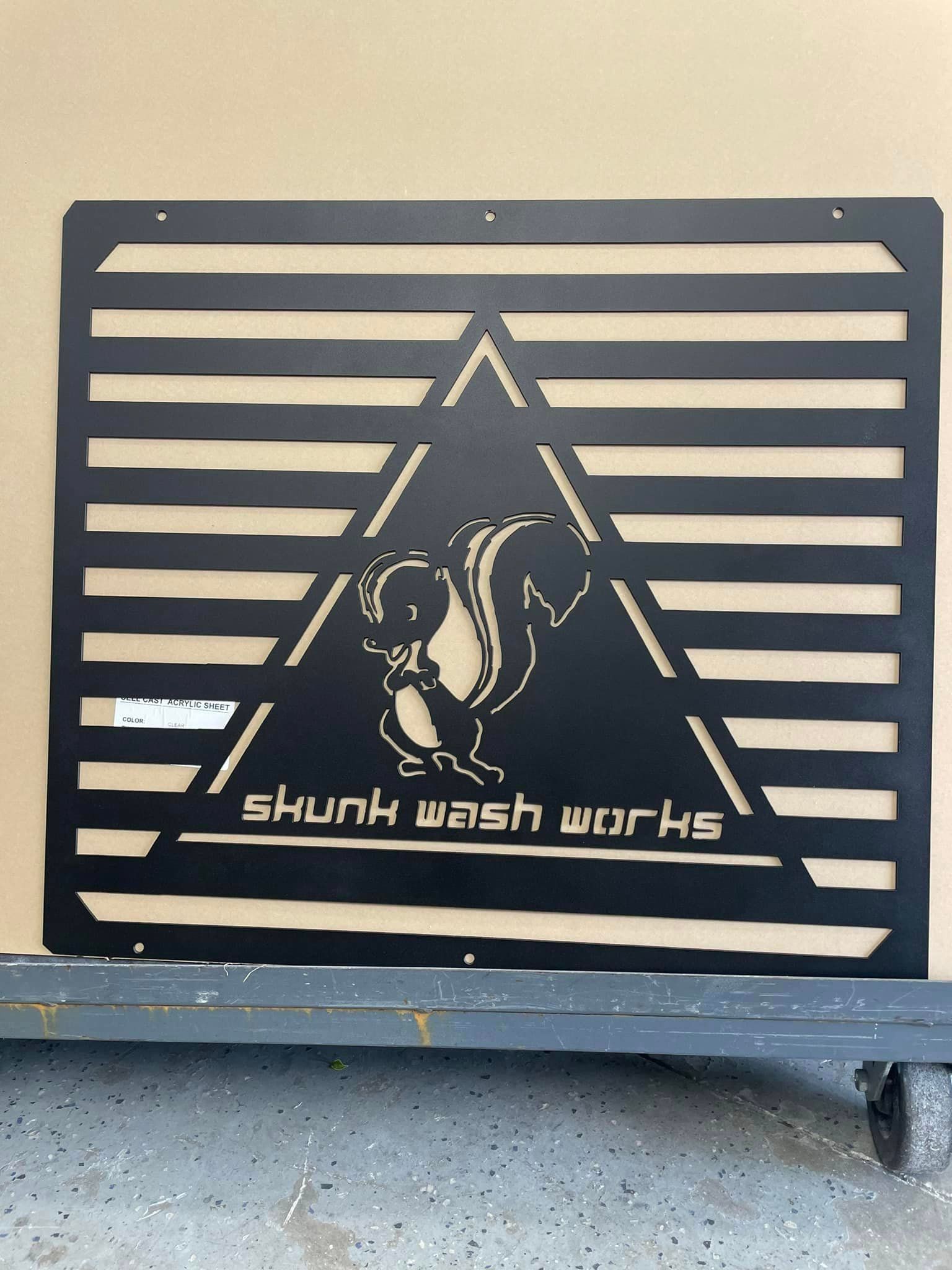 Black metal sign with the words 