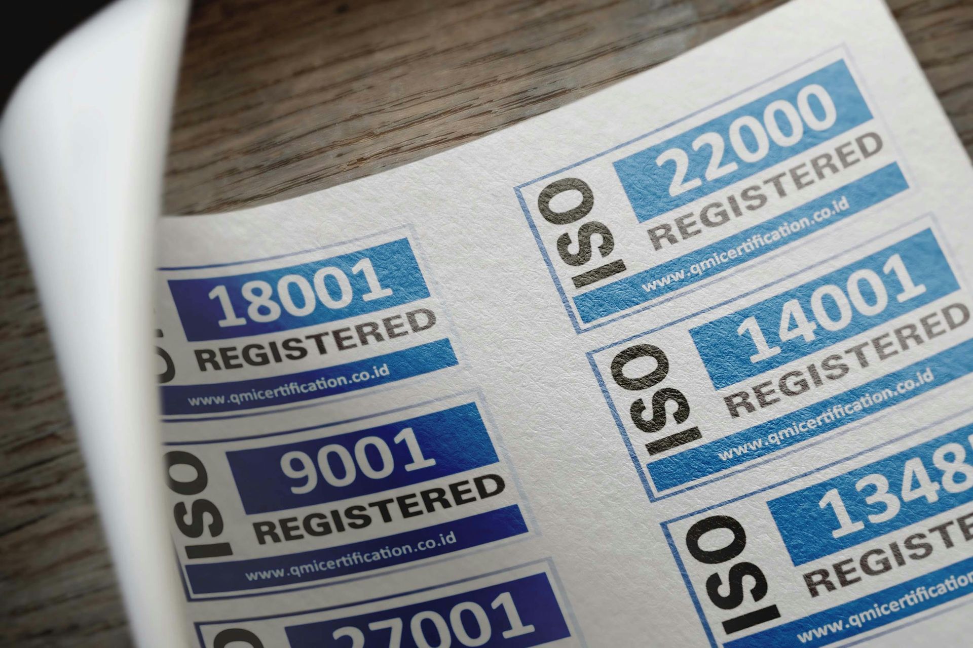 A sheet of paper with iso registered stickers on it