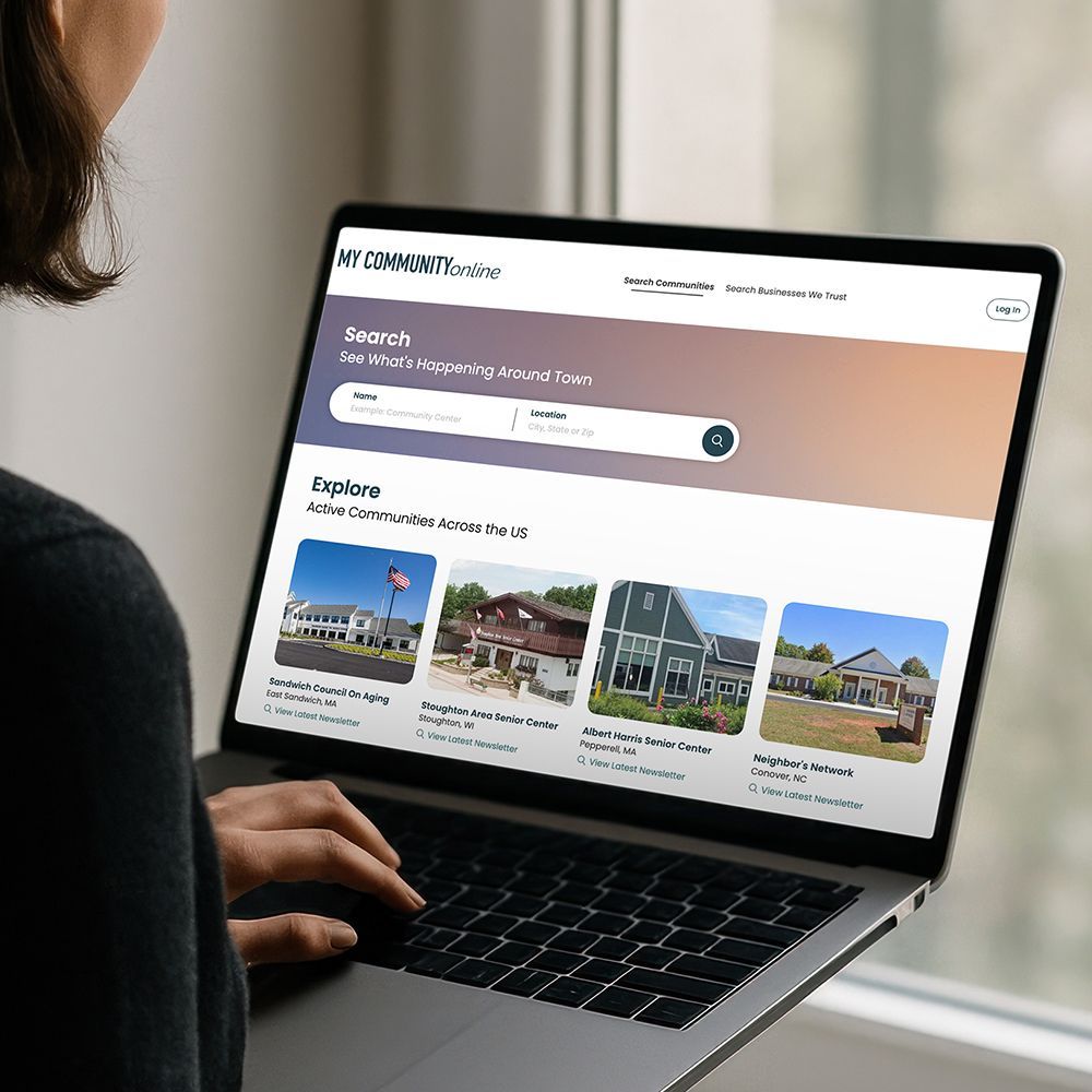 Person using a laptop showing the My Community Online website.