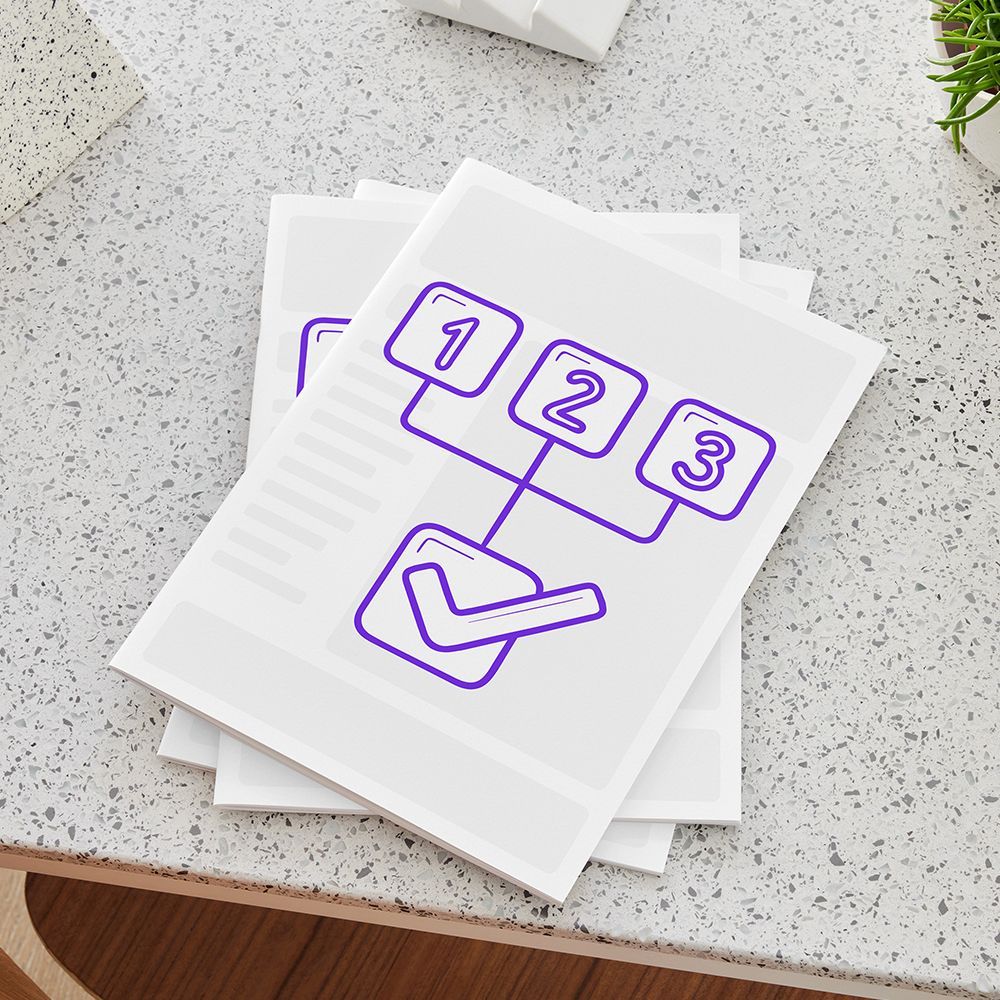 Stack of papers with a purple checklist illustration on a light speckled desk.