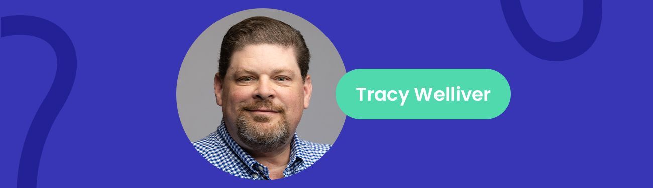 Tracy welliver is a man with a beard and a blue shirt.