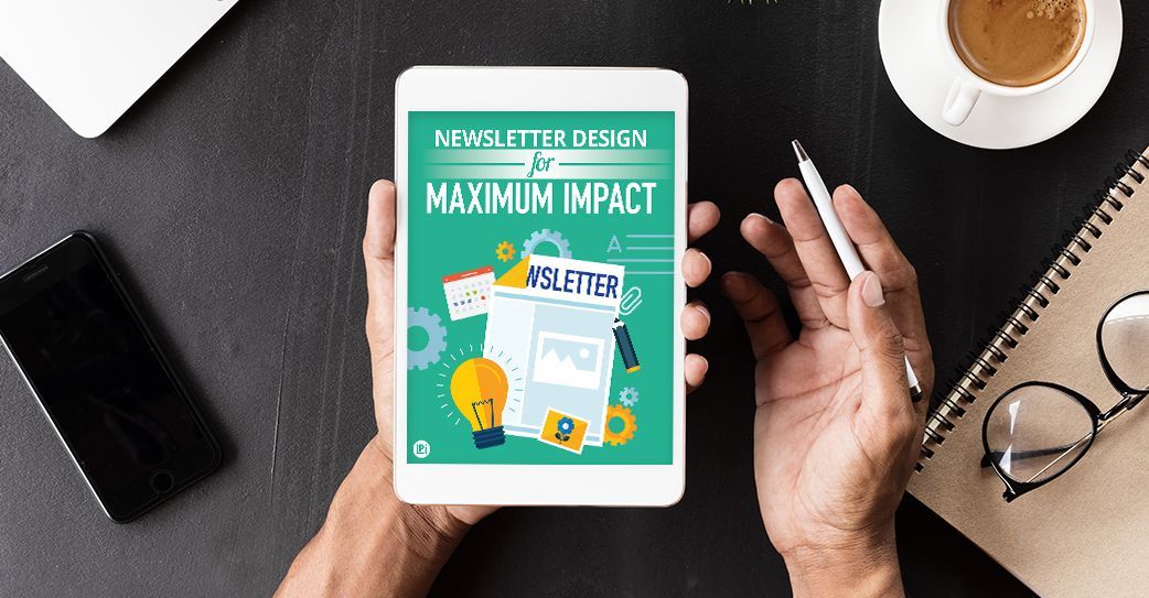 A person is holding a tablet with a newsletter on it.