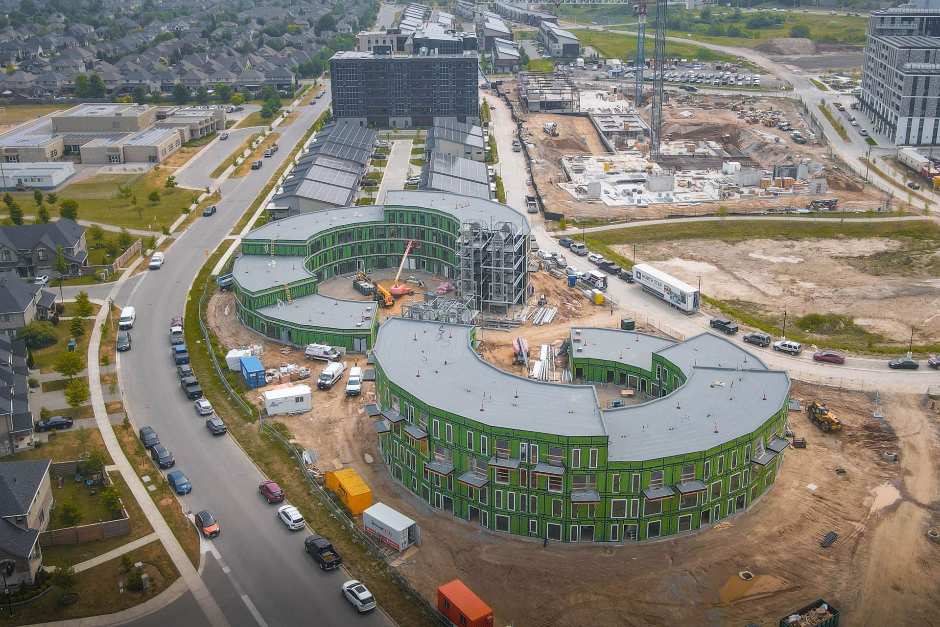an aerial view of a building under construction in a residential area .