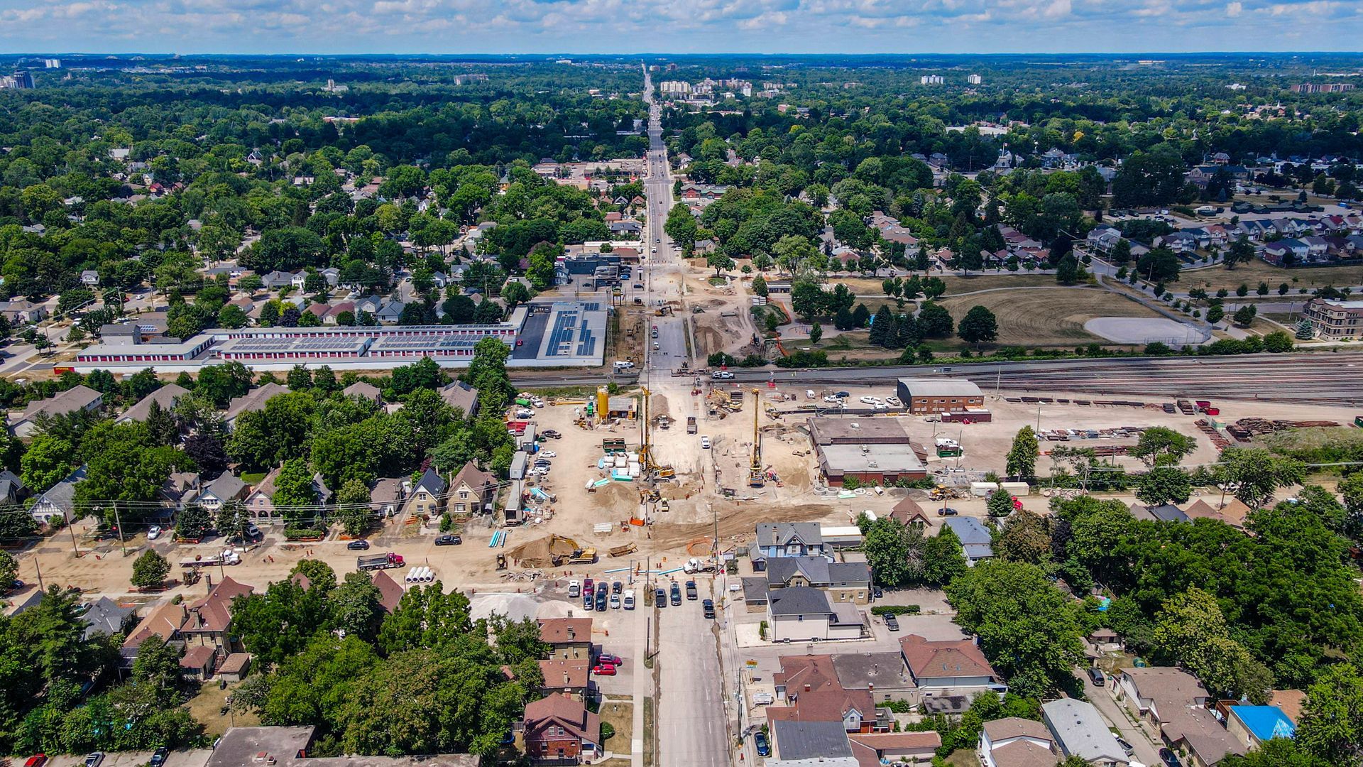 An aerial view of a city with a lot of trees and houses.