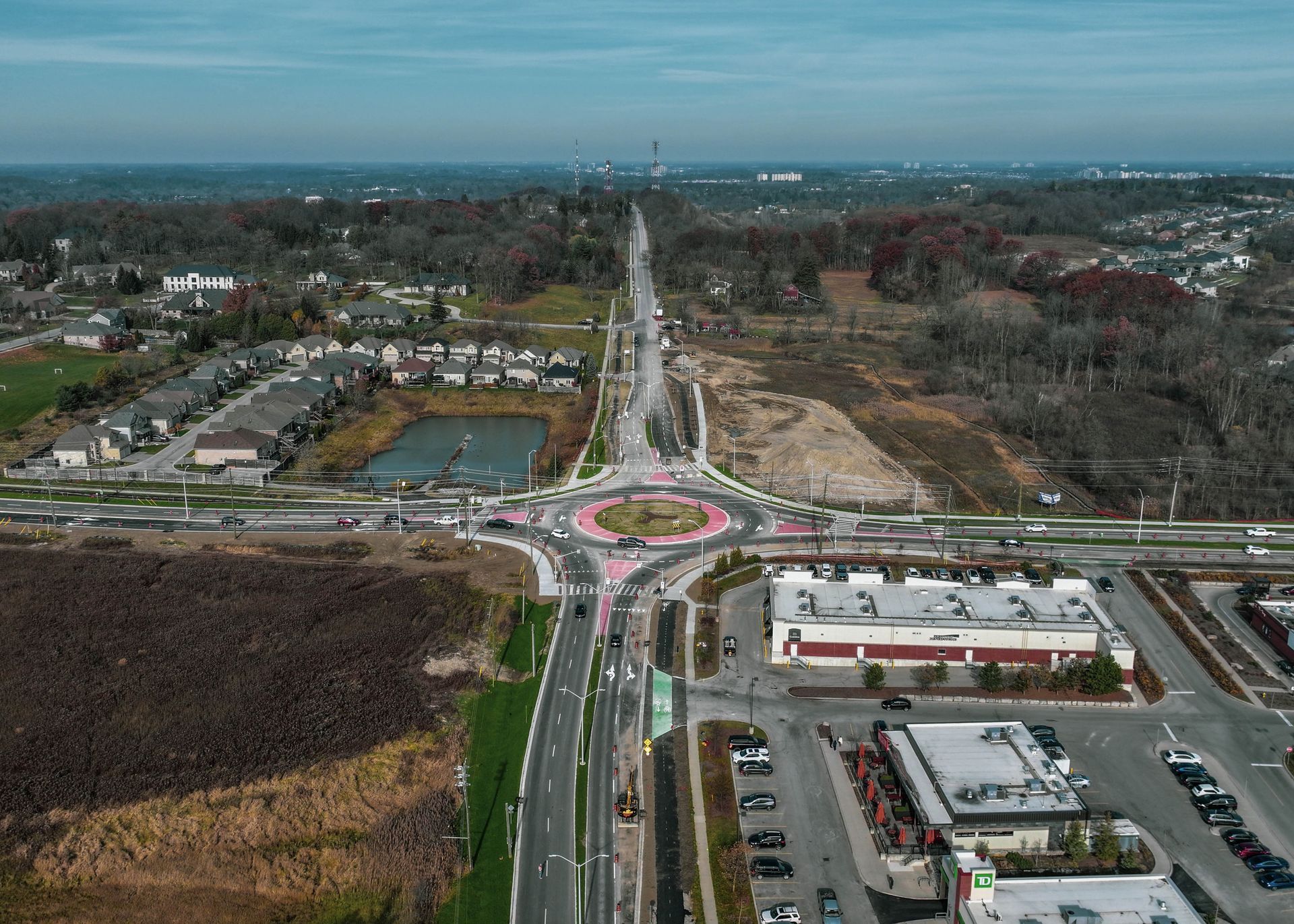 An aerial view of a busy intersection with a roundabout in the middle.