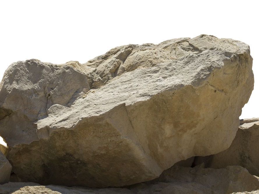 a large rock is sitting on top of a pile of rocks
