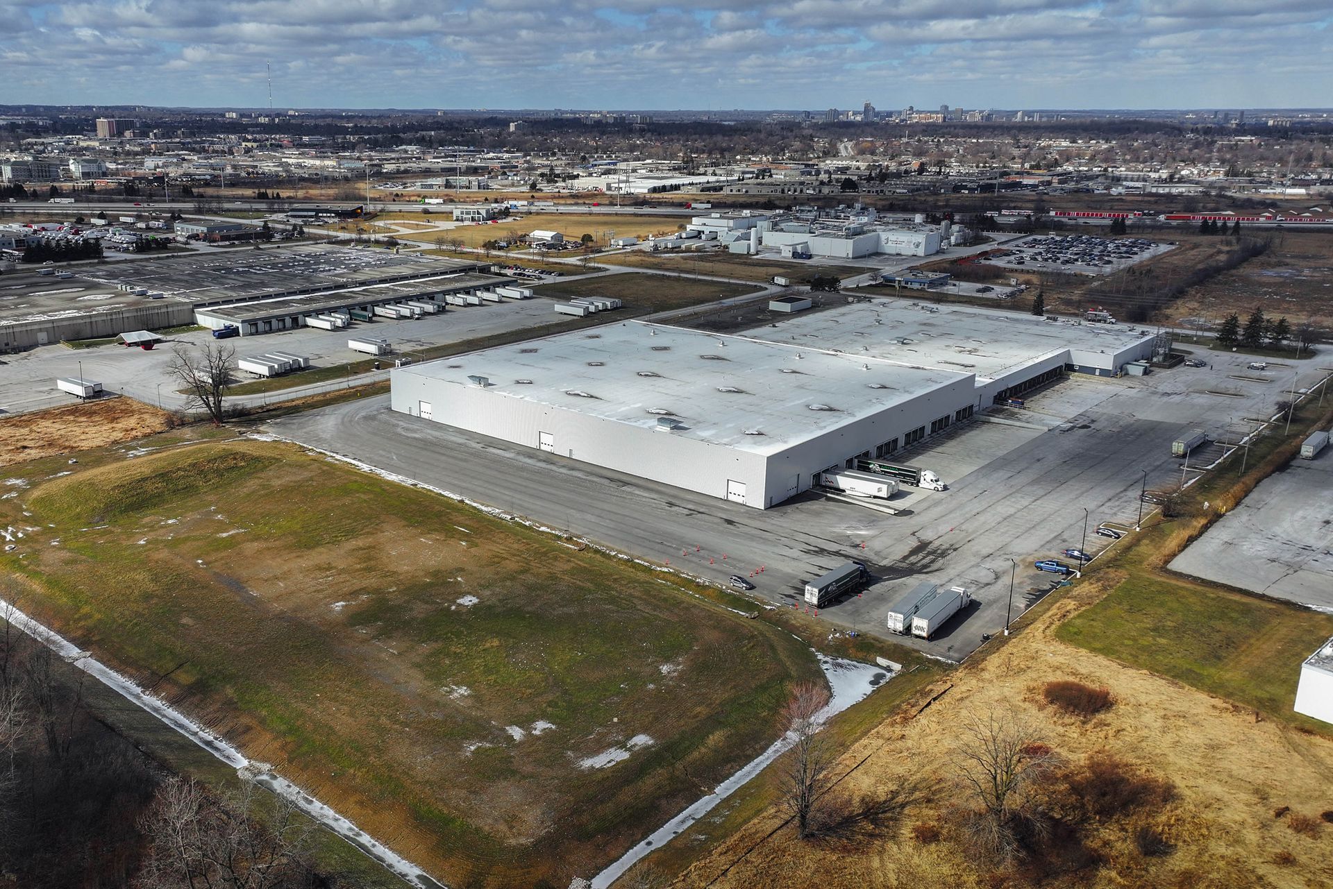 An aerial view of a large warehouse in the middle of a city.