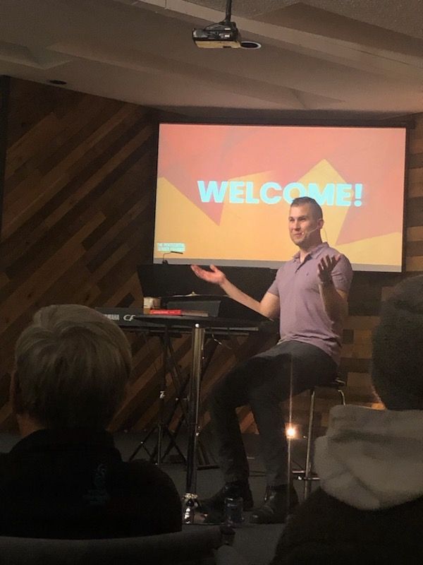 Joseph welcomes people to the book launch