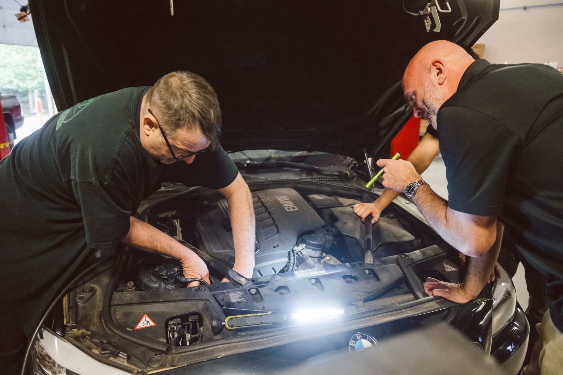 two technicians fixing a vehicle