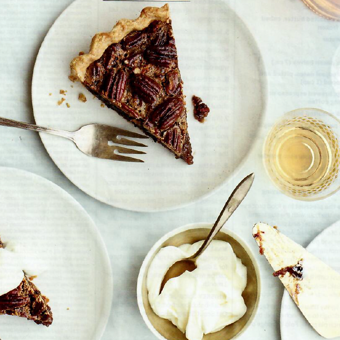 A slice of pecan pie on a plate with a fork