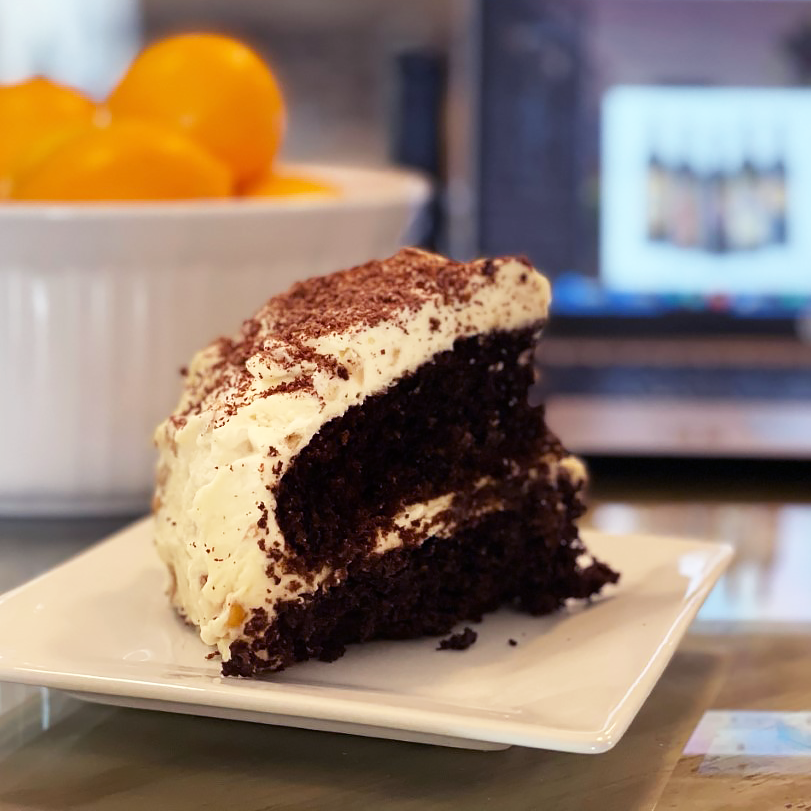 A slice of chocolate cake on a white plate