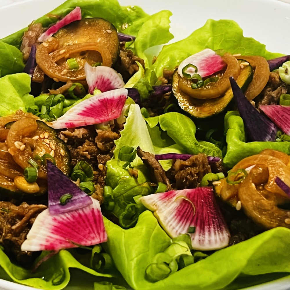 A close up of a salad with lettuce radishes and other vegetables