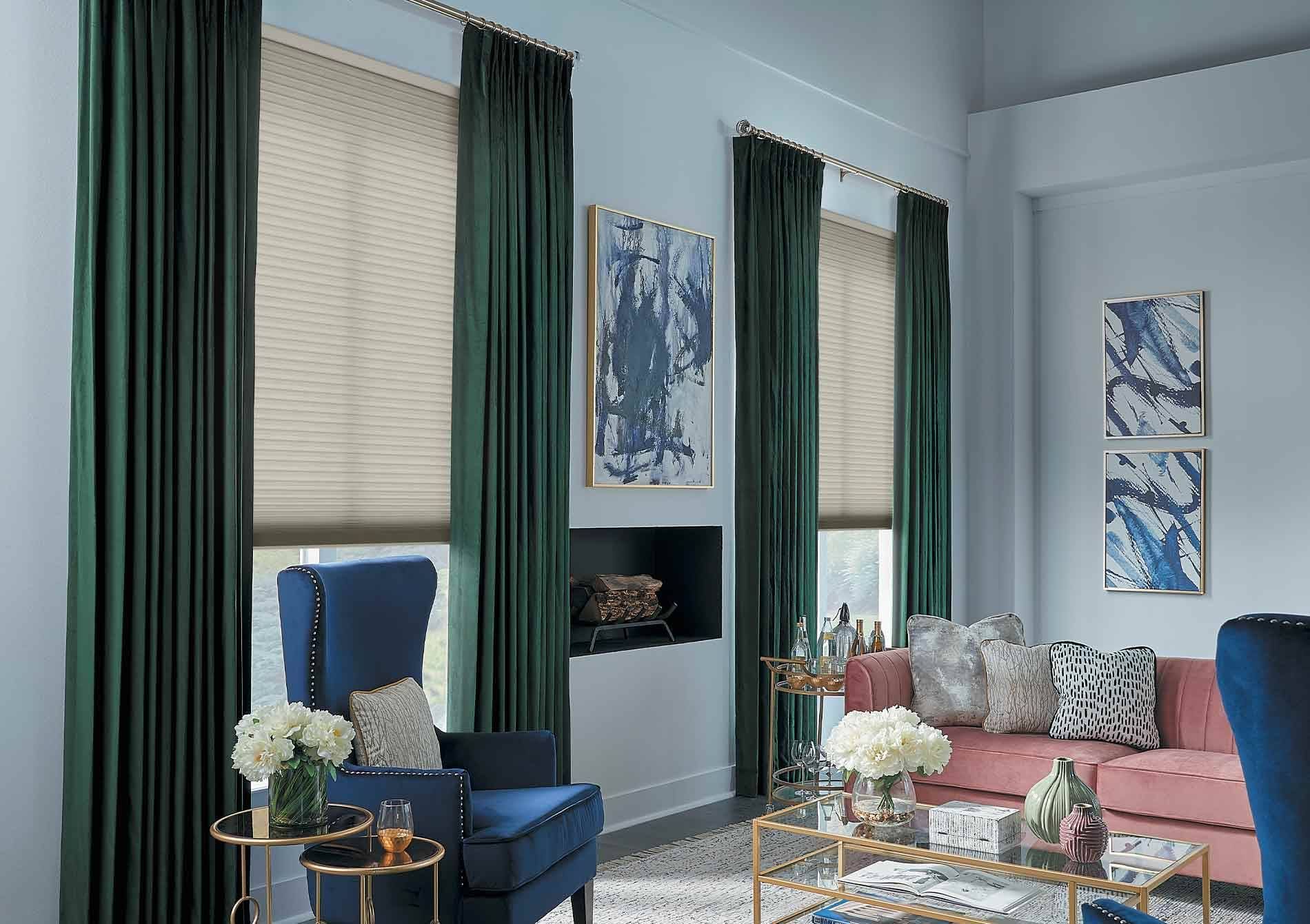 Layering neutral shades with jewel-tone drapery is a leading window treatment trend in 2026