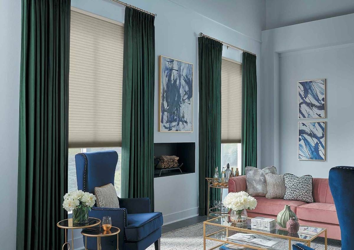 Layering neutral shades with jewel-tone drapery is a leading window treatment trend in 2026.