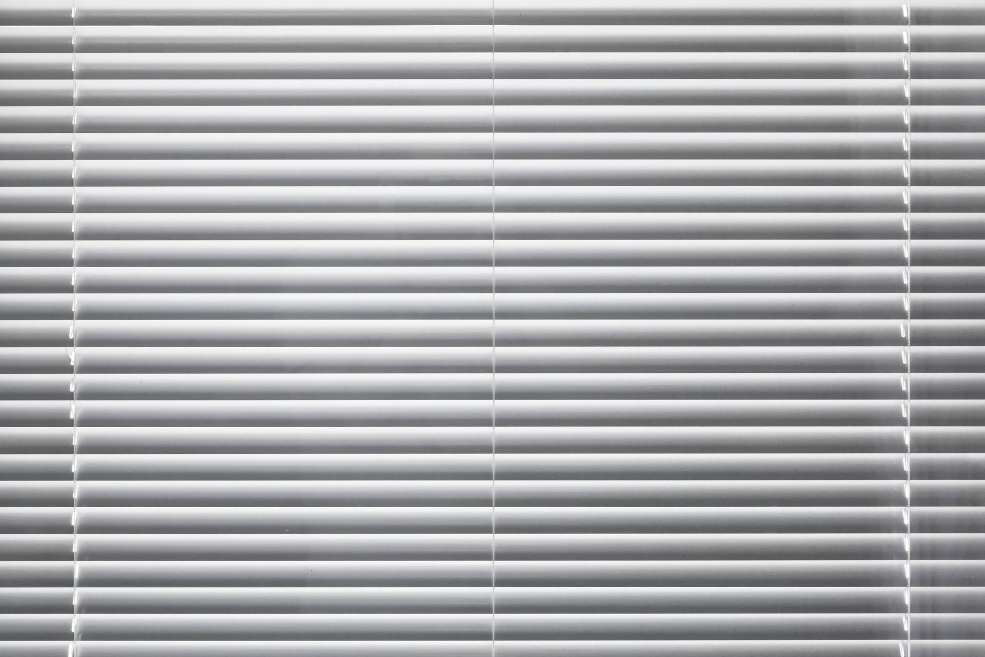 Modern white window blinds during the day at Blinded by Delight Window Coverings & Design near Boerne, Texas (TX)