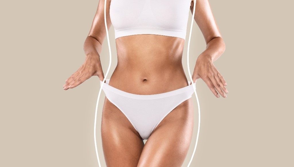 A woman in white underwear is measuring her waist.