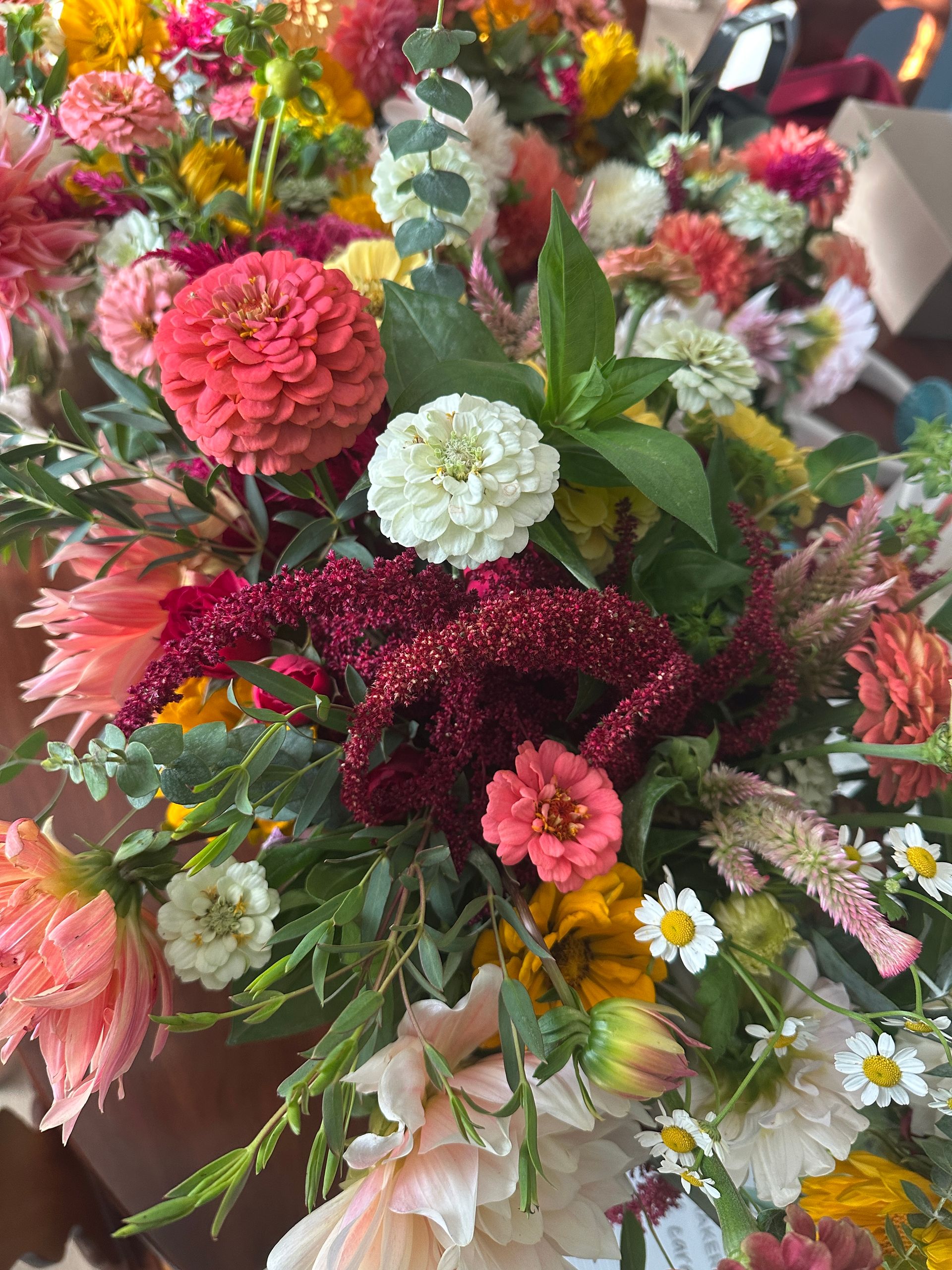 Colorful mixed bouquet with pink, white, red, and yellow flowers and green foliage