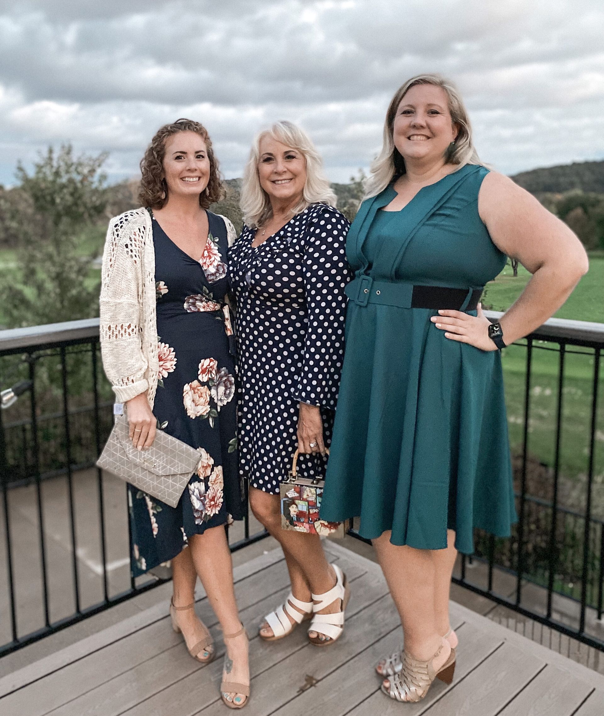 Three women are standing next to each other on a balcony. Three women are standing next to each other on a balcony.