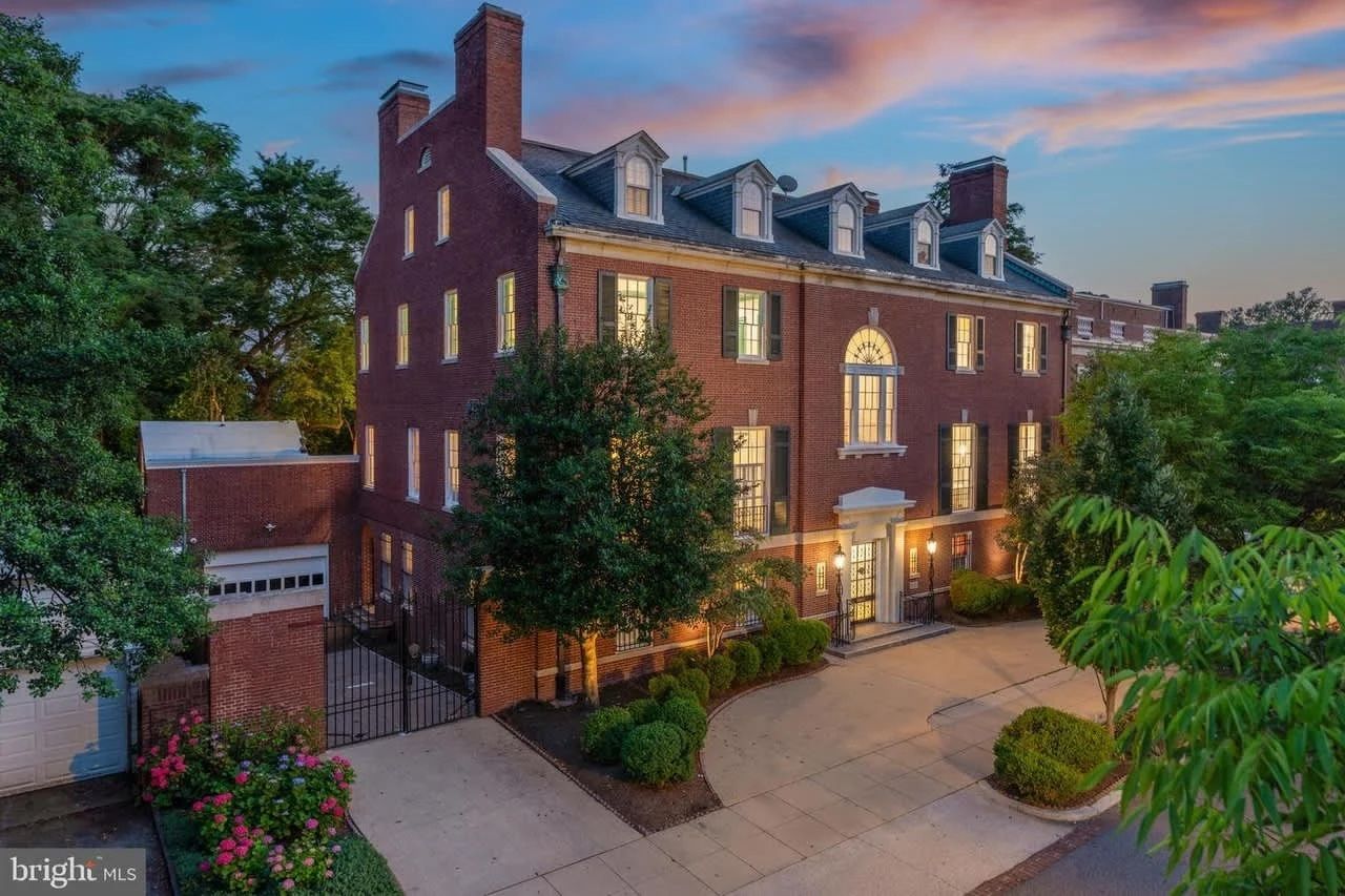 An aerial view of a large brick building with a driveway in front of it. An aerial view of a large brick building with a driveway in front of it.