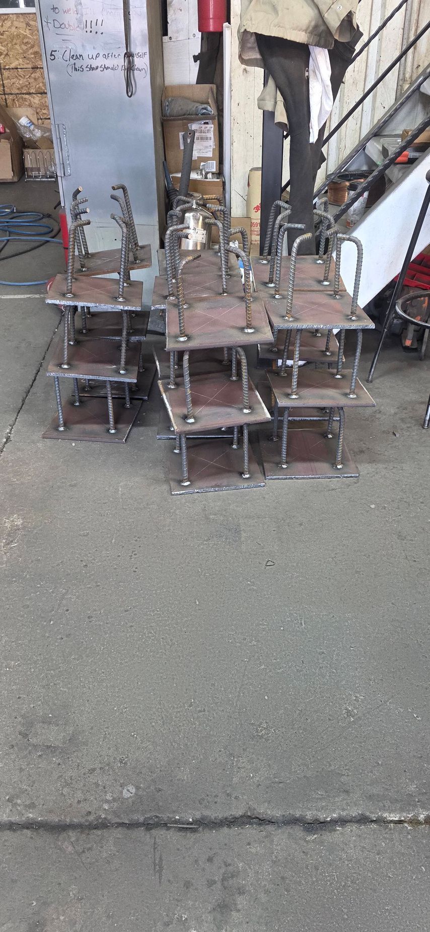 Stacked rusty metal carts and frames cluttering an outdoor alleyway