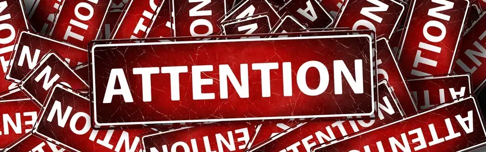 A red sign with the word attention written on it