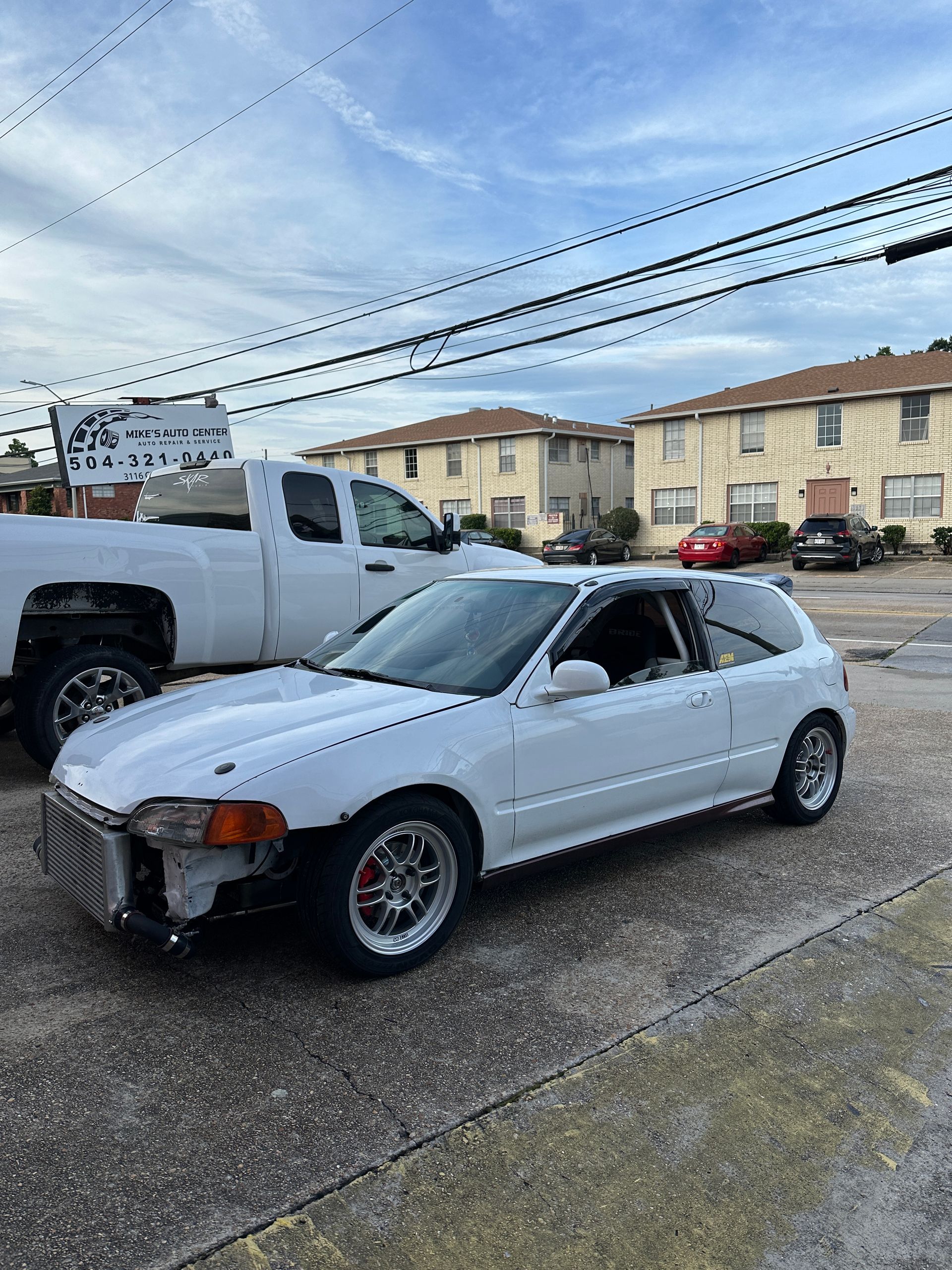 White, Modified Honda Civic Hatchback Parked on Asphalt | Mike's Auto Center